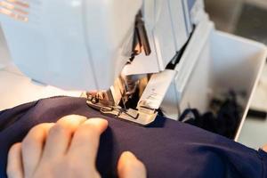 tailor overcasting the edge of fabric on serger photo