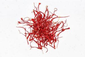 pile of crocus saffron threads close up on gray photo