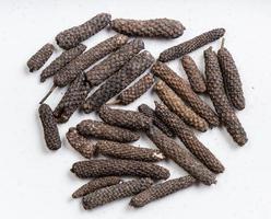 top view of java long pepper close up on gray photo