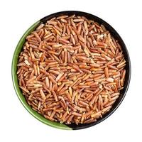 top view of raw red rice in round bowl isolated photo