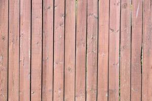 wooden fence planks painted with brown paint photo