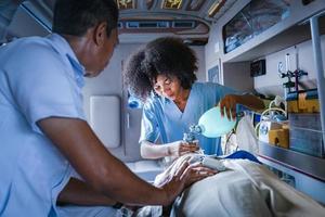 Team of paramedic is helping the senior patient who is stop breathing from car crash by using respirator for heart attack and street accident concept photo
