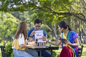 Group of Asian business startup people having a meeting project outside in the public park during the summer for college education and brainstorming photo