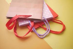 colorful shopping bag on color background photo