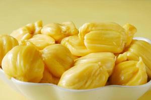 top view of slice of jackfruits in a bowl on table. photo