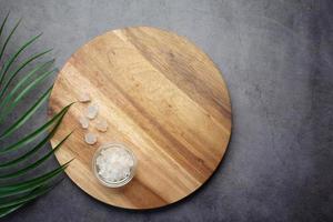 top view of pink rock salt on a chopping board on table photo