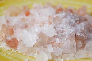 close up of pink rock salt in a bowl on table photo