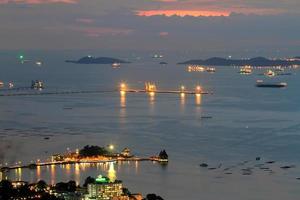 Port warehouse with cargoes and containers at night photo