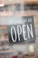 Open sign hanging front of cafe . photo