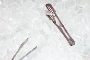 ice   with tongs closeup photo