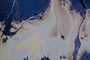 crude oil in sea water and rainbow reflection photo