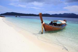 Traditional Thai longtail boat at the beach photo