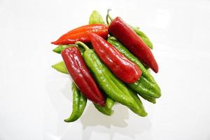 Green and red pepper on a white background photo