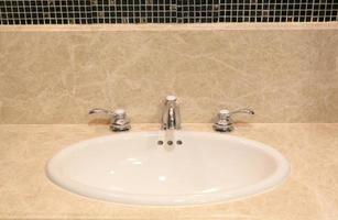 Bathroom interior with white sink and faucet photo