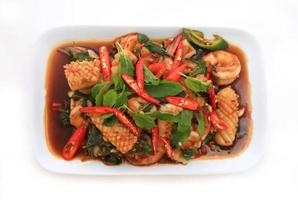 Spicy seafood fried served on white dish photo