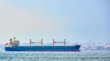 An bulk carrier or bulker sails in the sea to trade around the world photo