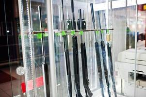 Different rifles on shelves store weapons on shop center. photo