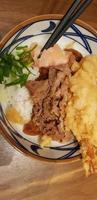 Japanese traditional food beef teriyaki with stickt rice and tempura shrimp sliced spring onion in a bowl photo