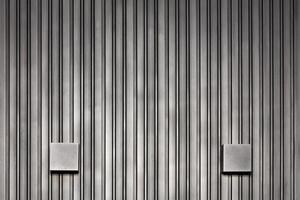 Stylish wall lights and wood wall with black silver vertical rails. photo