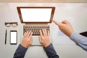 businessman hands working with digital tablet computer and smart phone with business graph on desk as concept. photo