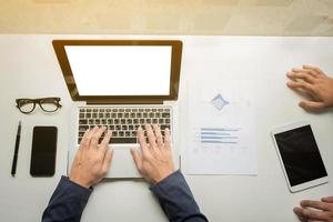 businessman hands working with digital tablet computer and smart phone with business graph on desk as concept. photo