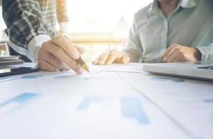 Two businessmen looking at report and having a discussion in office. business concept. photo