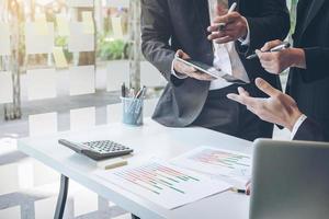 Team process, Business adviser analyzing financial figures denoting the progress in the work of the company photo