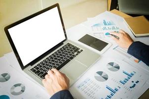 Image of business, businessman working with laptop, tablet and financial document data graph on table in office. photo