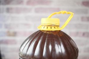 Mustard oil in a plastic jar close up , photo