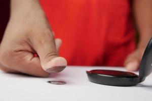 young men putting fingerprints on a paper close up , photo