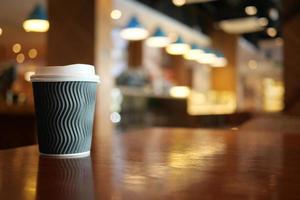 take away paper coffee cup o on cafe table photo