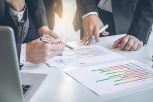 Teamwork process, Business adviser analyzing financial figures denoting the progress in the work of the company photo