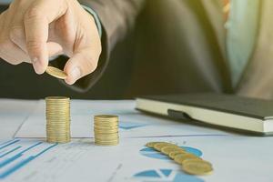 Money, Financial, Business Growth concept, Business man's hand put money coins to stack of coins. photo