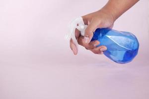 using disinfectant spray to clean table surface photo