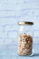 peanuts in a glass jar on table photo