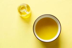 olive oils in a bowl on yellow background photo