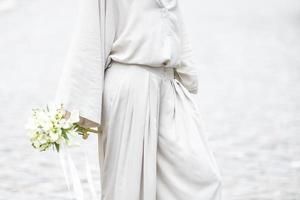 elements of a woman's casual suit with a bouquet of callas photo