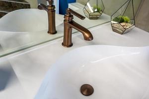 Soap and shampoo dispensers near Ceramic Water tap sink with faucet in expensive loft bathroom photo