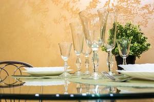 banquet table served with instruments and decorated with empty wine glasses photo