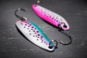 Two fishing lures on a dark table. Preparation for fishing. photo