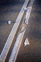 Brocken line of an asphalt road marking close-up photo