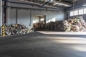 Paper pressed bales at the modern waste hazardous processing plant. Separate garbage collection. Recycling and storage of waste for further disposal. Business for sorting and processing of waste. photo