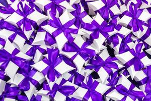 table with a purple tablecloth and small gifts for guests from the newlyweds photo