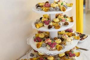 View of the served for decorated wedding dinner candy bar table with different sweet treats photo