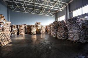 Paper pressed bales at the modern waste hazardous processing plant. Separate garbage collection. Recycling and storage of waste for further disposal. Business for sorting and processing of waste. photo