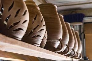 row of ceramic jugs are on the shelf photo