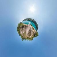 Little planet transformation of spherical panorama 360 degrees. Spherical abstract aerial view in field with awesome beautiful clouds. Curvature of space. photo