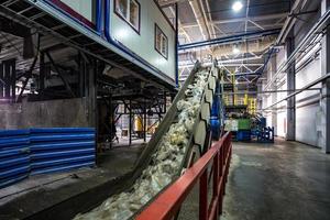 moving conveyor transporter on Modern waste recycling processing plant. Separate and sorting garbage collection. Recycling and storage of waste for further disposal. photo