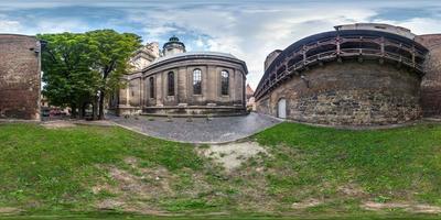 Full spherical seamless hdri panorama 360 degrees in the yard near fortress wall  uniate church in equirectangular projection with zenith and nadir, VR content photo