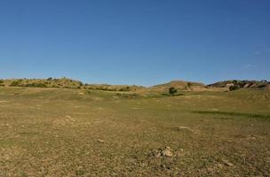 Rural Rugged Landscape with a Grass Field in North Dakota photo